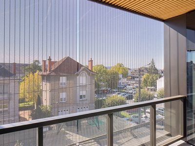 View through a sun protection facade made of metal mesh
