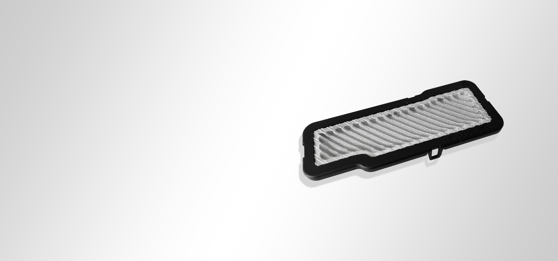 Wire mesh piece with plastic overmoulding and pleated woven wire cloth