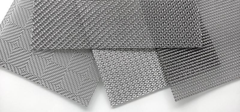 A piece of plastic mesh with small square meshes on gray background.