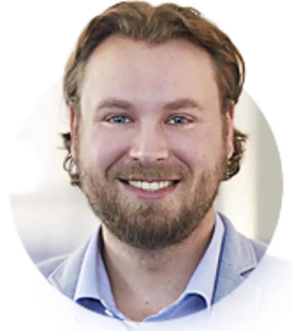 Portrait photo of Mr. Sickmann, a smiling man with a beard and a blue jacket, employee at Haver & Boecker.