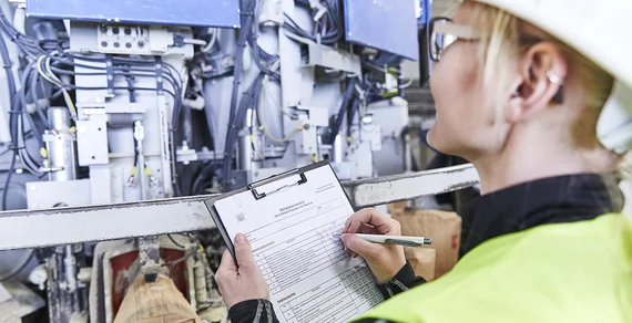 A service technician noting machine information