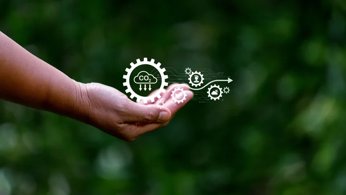 Une main tient des icônes sur le thème de l'environnement et notamment du captage du CO2.