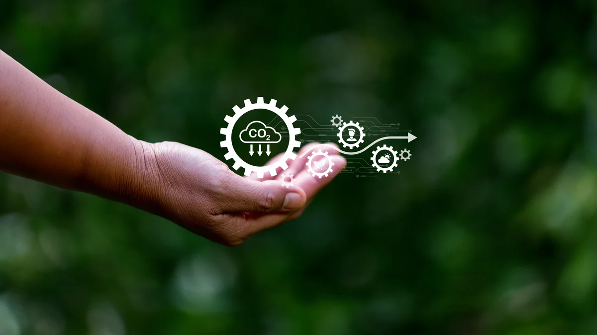 Hand holds icons related to the environment and, above all, CO2 capture.