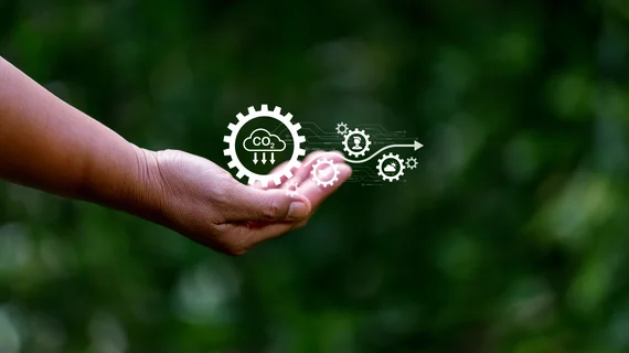 Une main tient des icônes sur le thème de l'environnement et notamment du captage du CO2.