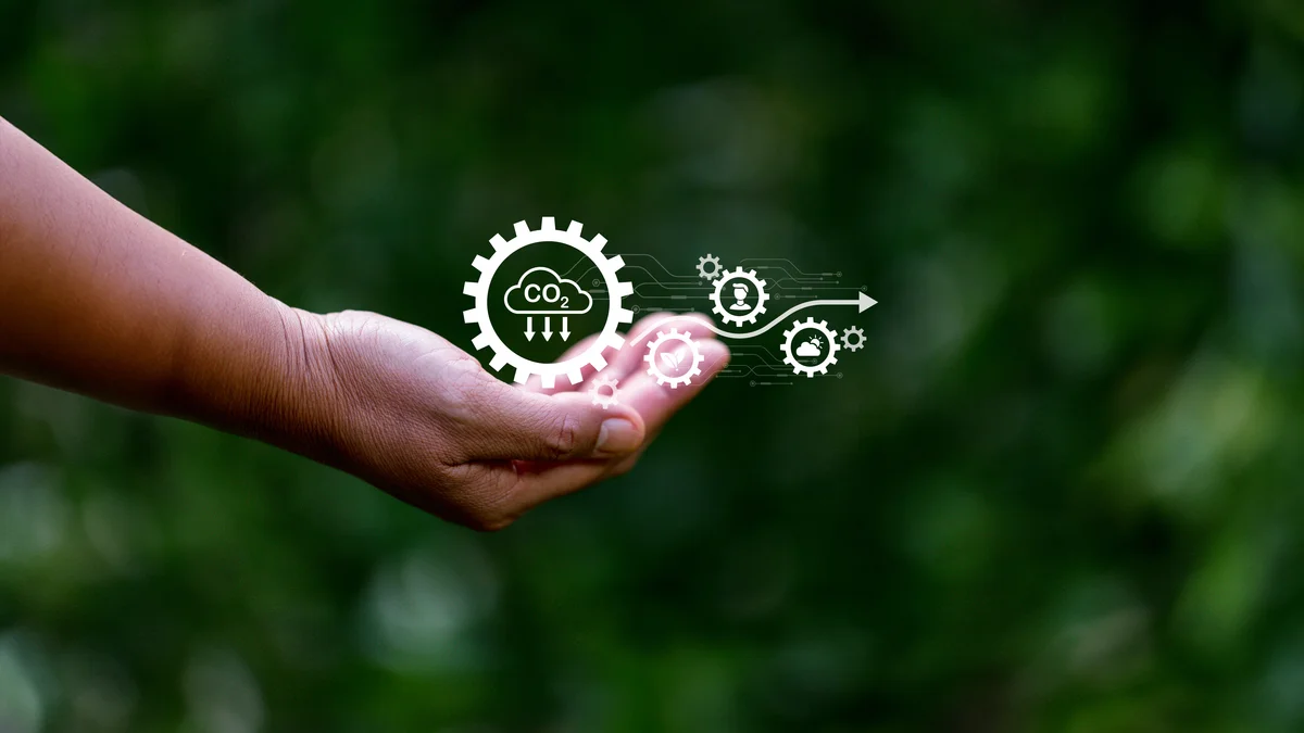 Une main tient des icônes sur le thème de l'environnement et notamment du captage du CO2.