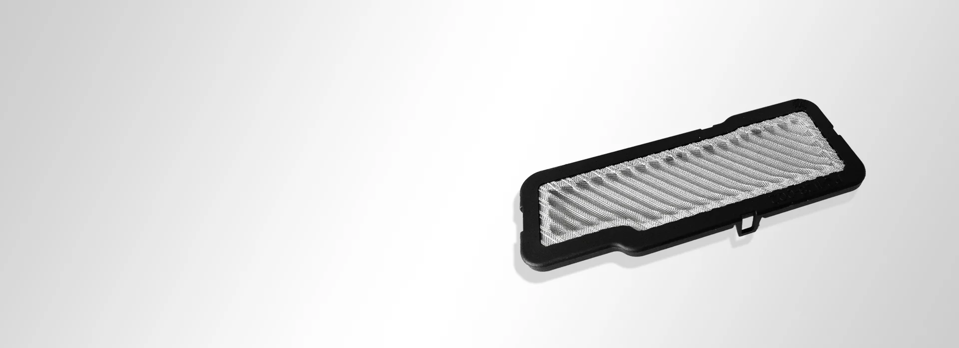 Wire mesh piece with plastic overmoulding and pleated woven wire cloth