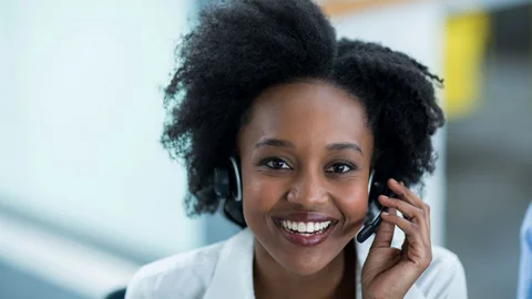 Woman with a headset answering a hotline call.