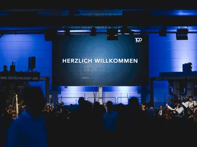 The Northwest German Philharmonic Orchestra performs at HAVER & BOECKER’s 100th anniversary concert in Oelde, celebrating the company’s history and innovation.