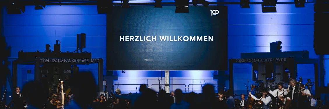The Northwest German Philharmonic Orchestra performs at HAVER & BOECKER’s 100th anniversary concert in Oelde, celebrating the company’s history and innovation.
