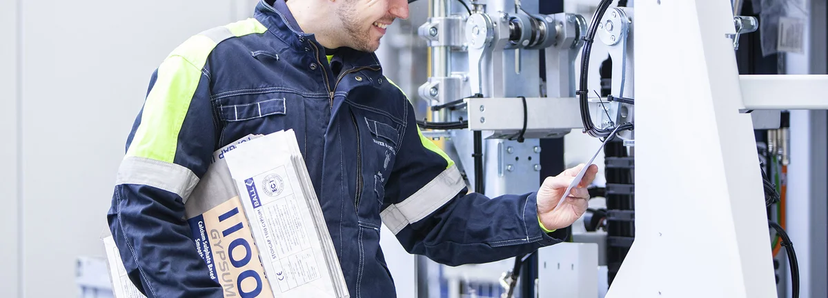 A service technician checks machine data