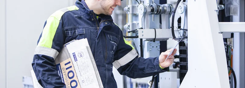 A service technician checks machine data