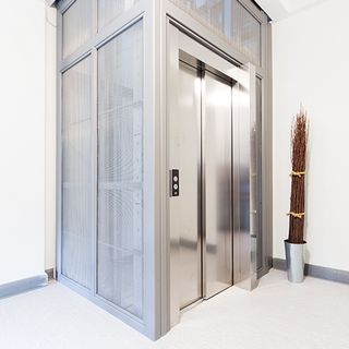 Elevator cladding with stainless steel mesh