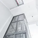 Elevator cladding with stainless steel mesh