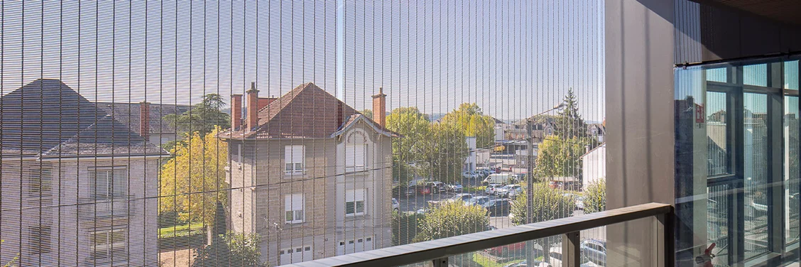 View through a sun protection facade made of metal mesh