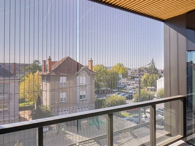 View through a sun protection facade made of metal mesh